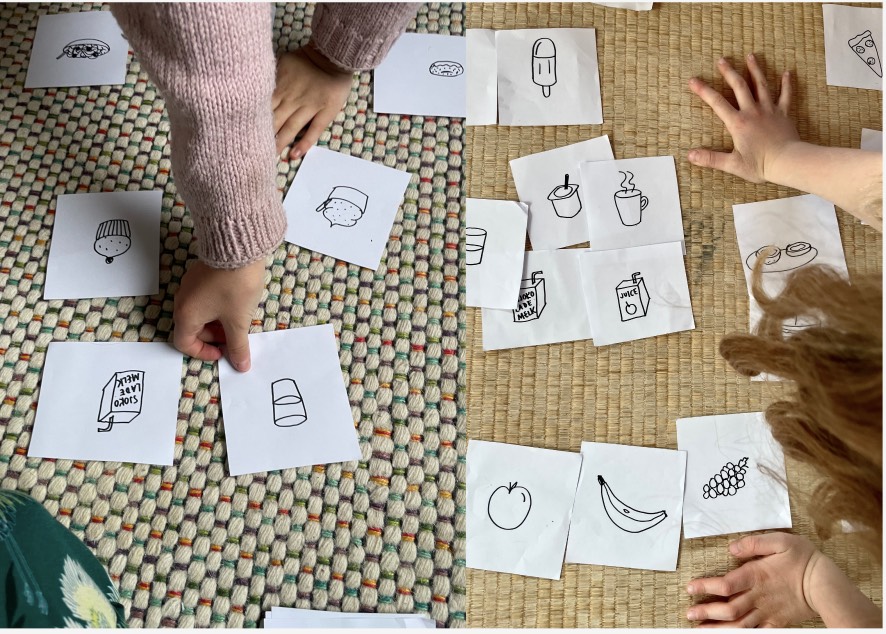 Barnehender sorterer lapper med tegninger av mat